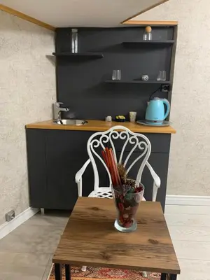 a kitchen with a table with a vase on a table at Valeria House in Istanbul