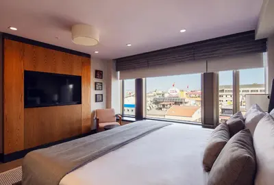 a bedroom with a large bed and a flat screen tv at Root Hotel Karaköy Bosphorus in Istanbul