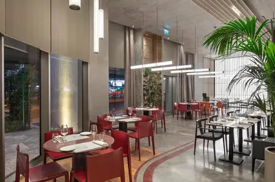 a dining room with tables and red chairs at Melas Hotel Istanbul in Istanbul