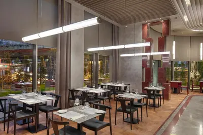 a restaurant with tables and chairs in a room at Melas Hotel Istanbul in Istanbul