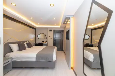 a bedroom with a large bed and a mirror at White Corner Hotel in Istanbul