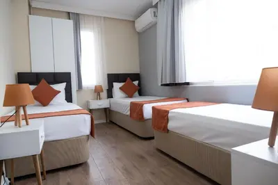 a hotel room with two beds and a window at GREEN SUITES BURSA in Bursa