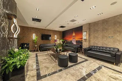 a lobby with black leather couches and tables at The Halich Hotel Istanbul Karakoy - Special Category in Istanbul