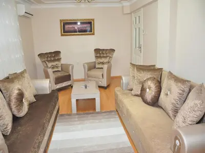 a living room with a couch and two chairs at Yilmaz Apart in Istanbul