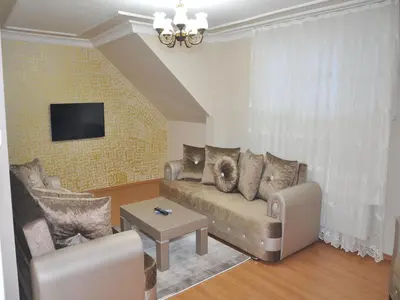 a living room with a couch and a tv at Yilmaz Apart in Istanbul