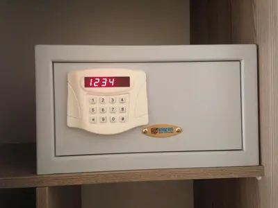 a microwave with a clock and a thermometer on a shelf at Yilmaz Apart in Istanbul