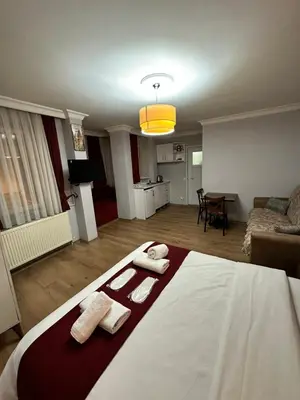a bedroom with a bed with two towels on it at Taksim Rain Suite in Istanbul