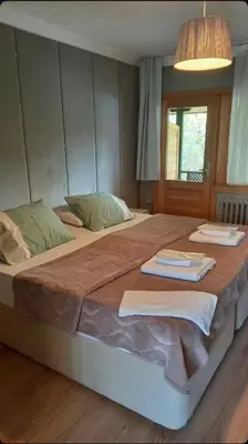 a bedroom with a large bed with two towels on it at Zumrut Bahce in Gokcedere