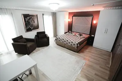 a bedroom with a bed and a couch and a chair at Kubbe House in Istanbul
