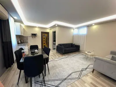 a living room with a table and chairs and a couch at Kubbe House in Istanbul