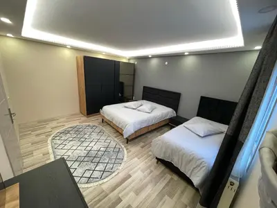 a room with two beds and a large window at Kubbe House in Istanbul