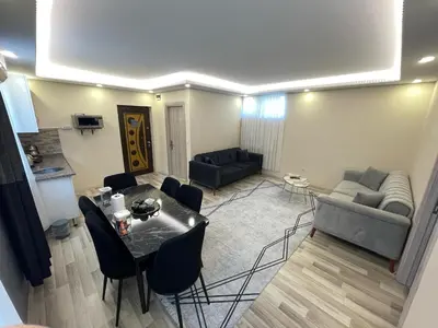 a living room with a table and chairs and a couch at Kubbe House in Istanbul