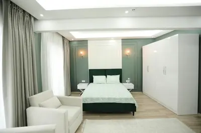 a bedroom with a bed and a white couch at Kubbe House in Istanbul
