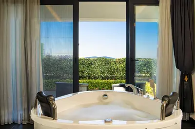 a bath tub in a room with a large window at La Cielo Hotel Bostancı in Istanbul