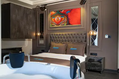 a bedroom with a bed and a painting on the wall at La Cielo Hotel Bostancı in Istanbul