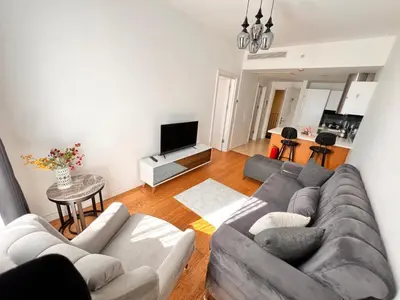 a living room with a couch and a tv at Divan Residence - Güneşli Near Ataköy Metro Station in Istanbul