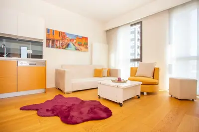a living room with a couch and a table at Divan Residence - Güneşli Near Ataköy Metro Station in Istanbul