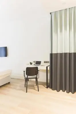 an office with a desk and a chair and a curtain at Anemon Bakırköy in Istanbul