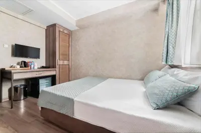 a hotel room with a bed and a desk at Castle Franco Suites in Istanbul