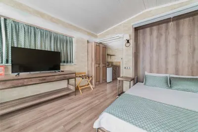 a bedroom with a bed and a flat screen tv at Castle Franco Suites in Istanbul