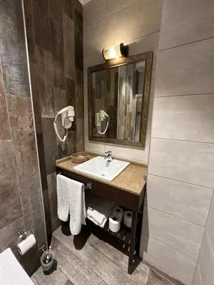 a bathroom with a sink and a mirror at Castle Franco Suites in Istanbul