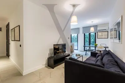 a living room with a couch and a tv at X Flats Vilhelm in Istanbul