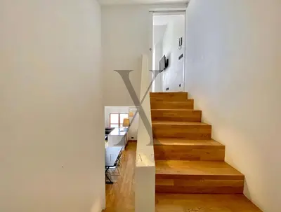 a staircase in a home with white walls and wooden floors at X Flats Vilhelm in Istanbul
