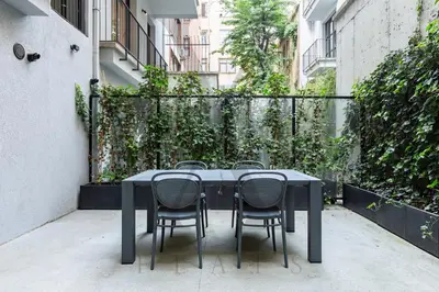 a black table and chairs sitting on a patio at X Flats Vilhelm in Istanbul