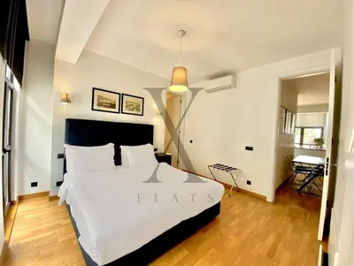 a bedroom with a large white bed in a room at X Flats Vilhelm in Istanbul