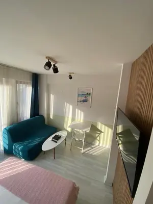 a living room with a blue couch and a table at Istanbul Hub Flats in Istanbul
