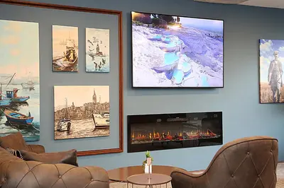 a living room with a fireplace and pictures on the wall at Kerthill Hotel in Istanbul