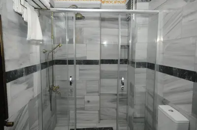 a shower with a glass door in a bathroom at The Old Ottoman Castle in Istanbul