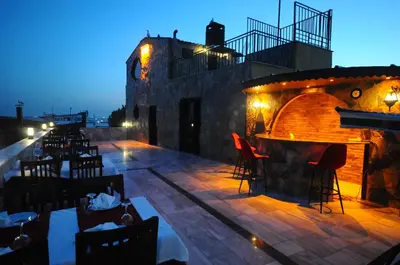 a restaurant with a bar on a patio at night at The Old Ottoman Castle in Istanbul