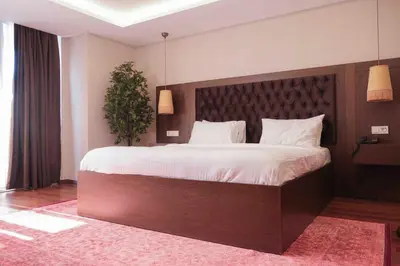 a bedroom with a large bed with a large headboard at Phellos Suites Boutique Hotel in Sile