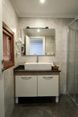 a bathroom with a sink and a mirror at Phellos Suites Boutique Hotel in Sile