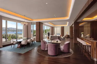 a living room with tables and chairs and windows at Mandarin Oriental Bosphorus, Istanbul in Istanbul