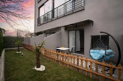 a house with a swing on the side of it at Melanj Airport Hotel in Arnavutköy