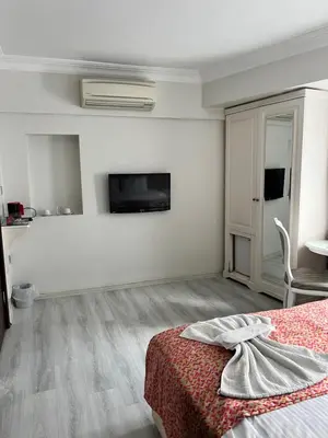 a bedroom with a bed and a tv on the wall at Nacre Residence in Istanbul