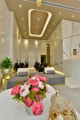 a lobby with a table with pink flowers on it at Ghan Hotel in Istanbul