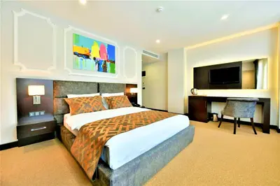 a hotel room with a large bed and a desk at Ghan Hotel in Istanbul