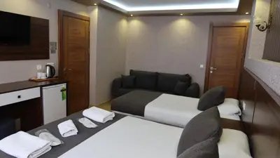 a hotel room with a bed and a tv at ÜSKÜDAR OTEL in Istanbul