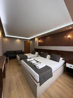 a hotel room with two beds and a couch at ÜSKÜDAR OTEL in Istanbul