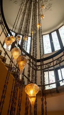 a large chandelier hanging from a ceiling with windows at BANDIRMA PALAS OTEL in Bandırma