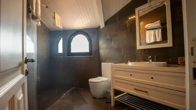 a bathroom with a sink and a toilet and a window at BANDIRMA PALAS OTEL in Bandırma
