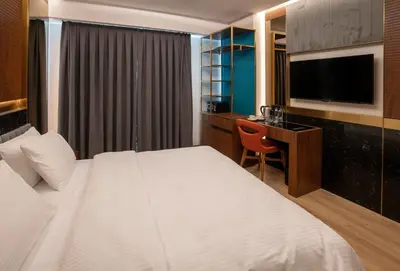 a hotel room with a bed and a desk and a television at Henna Hotel Istanbul in Istanbul