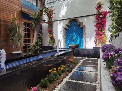 a garden with flowers in front of a building at Henna Hotel Istanbul in Istanbul