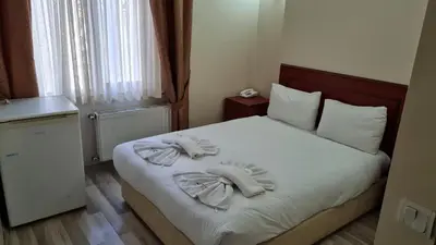 a bedroom with a bed with towels on it at EMOS HOTEL in Istanbul