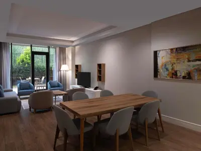 a living room with a table and chairs at Movenpick Living Istanbul West in Istanbul