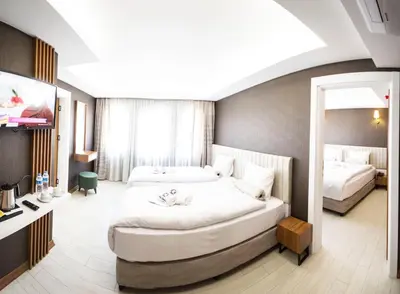 a hotel room with two beds and a mirror at KAR BEYAZ HOTEL BURSA in Bursa