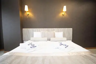 a large white bed with two towels on it at KAR BEYAZ HOTEL BURSA in Bursa